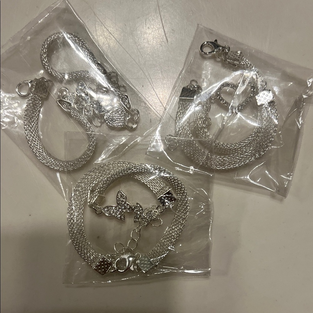 3 Silver Bracelets. Butterfly, Heart, and Bird charms.
